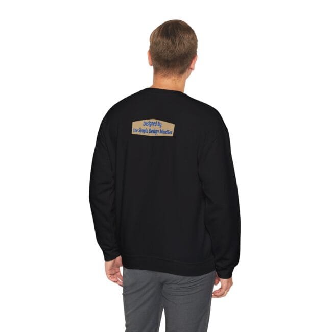 Back view of a person in a black sweatshirt; a small tan label on the upper back reads 'Designed By The Simple Design MindSet'.