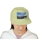 Light green cap with a rectangular image on the front reading 'Walk For Your Health' over a scenic road and mountains backdrop, worn by a person.