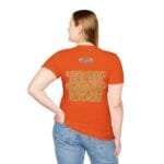 Back view of a person wearing an orange T-shirt with a yellow-lettered quote on the back: 'A princess is a girl or a woman who conserves her ethics'.