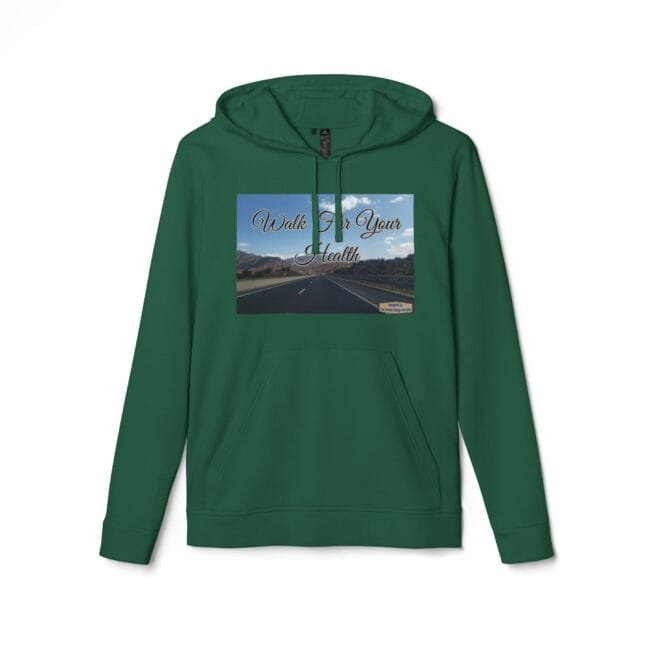 Green hoodie with a printed rectangular image on the chest: a highway through desert mountains under a blue sky, overlaid with cursive text 'Walk For Your Health'
