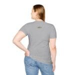 Back view of a person wearing a light gray t-shirt and blue jeans, with a small rectangular label on the upper back.