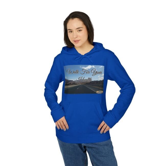 Woman modeling a bright blue hoodie with a rectangular graphic on the chest showing a road and the text 'Walk For Your Health'.