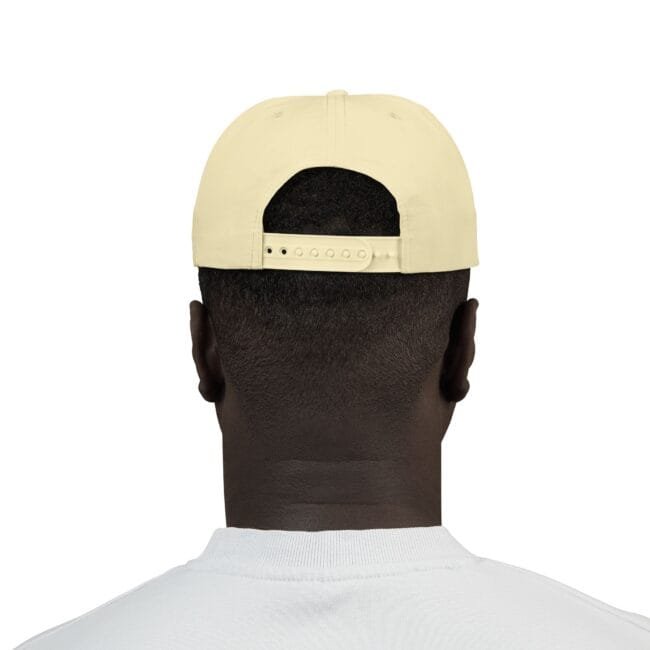 Back view of a person wearing a pale yellow baseball cap with an adjustable strap at the back on a white shirted figure.