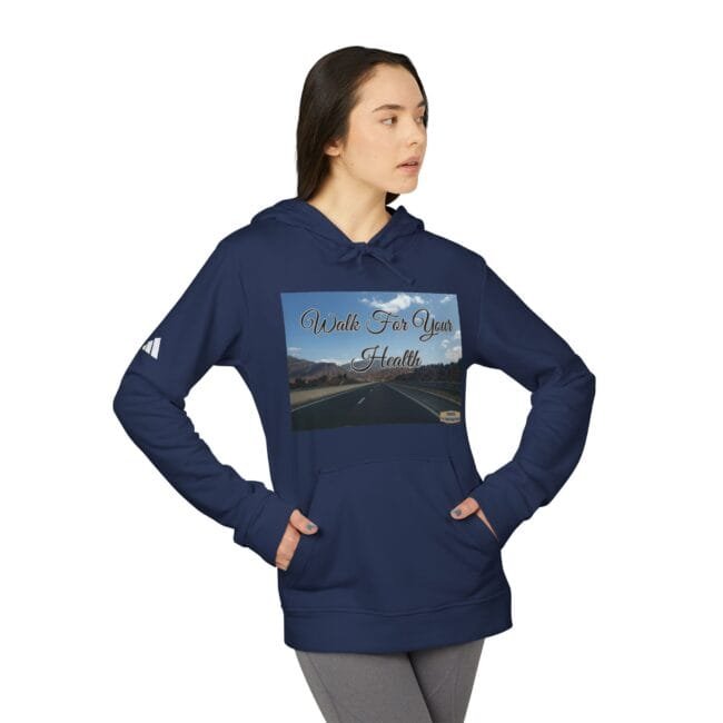 Woman wearing a navy hoodie with a front graphic that says 'Walk For Your Health' over a road landscape image on the chest area.