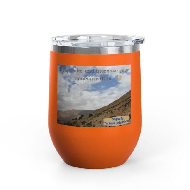 Orange insulated tumbler with a scenic hillside photo and the caption 'Keep calm and increase your concentration' on a sticker-like label.
