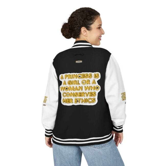 Back view of a woman wearing a black varsity jacket with white sleeves; gold text on the back reads: 'A princess is a girl or a woman who conserves her ethics'.