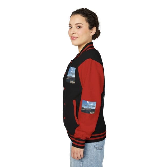 Side view of a woman wearing a black and red varsity jacket with patches on the chest and sleeve.