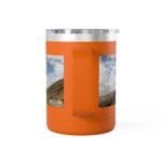 Orange insulated tumbler with a clear lid, featuring a vertical grip and two landscape photo decals on the sides