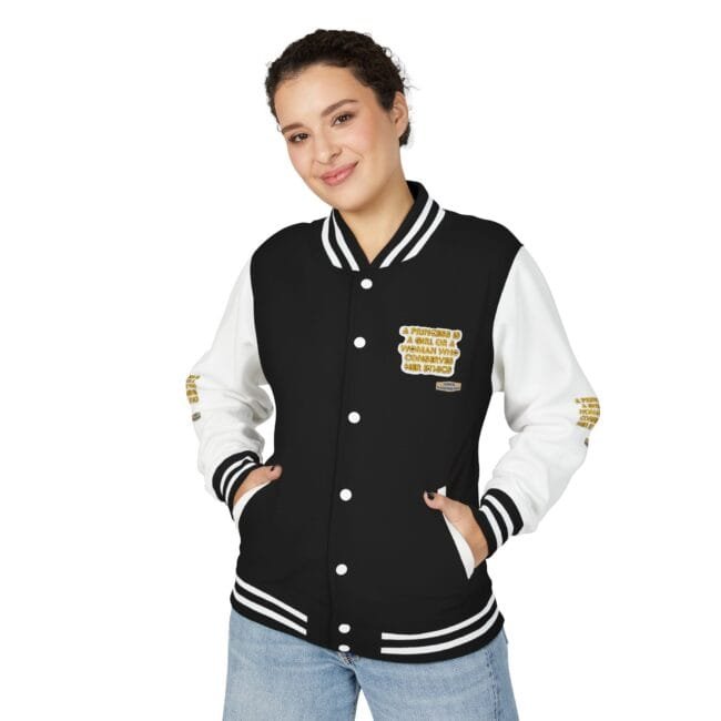 Woman wearing a black and white varsity jacket with striped cuffs and collar, hands in pockets, smiling at the camera