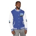 Man wearing a blue and white varsity jacket with striped cuffs and collar, standing against a white background.