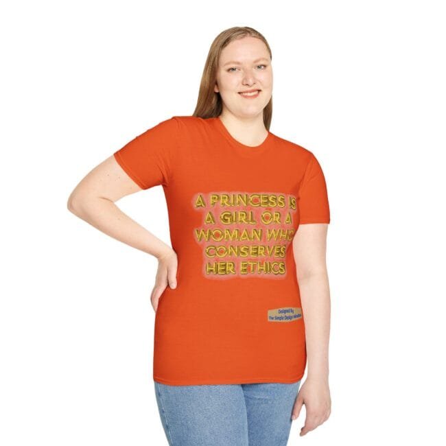Woman wearing an orange t-shirt with the slogan: 'A princess is a girl or a woman who conserves her ethics', standing with one hand on hip.