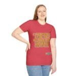 Woman wearing a red T-shirt with gold text: 'A PRINCESS IS A GIRL OR A WOMAN WHO CONSERVES HER ETHICS' and a small label at the hem area.