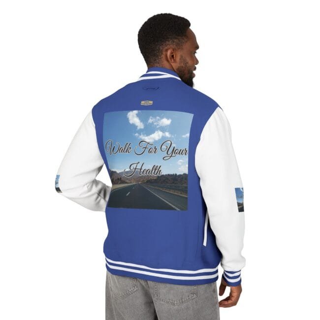 Man wearing a blue and white varsity jacket; back graphic shows a highway under a blue sky with the phrase 'Walk For Your Health'.
