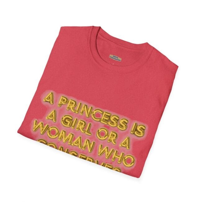 Pink folded T-shirt with a bold, neon-yellow 3D text: 'A PRINCESS IS A GIRL OR A WOMAN WHO ...'
