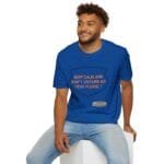 Smiling man wearing a blue T-shirt with an orange slogan: 'Keep calm and don't disturb my head please!'