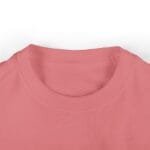 Close-up of a pink crew-neck T-shirt neckline showing the ribbed collar and fabric texture.