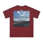 Maroon T‑shirt with a square graphic: an open highway toward mountains under a blue sky and the script 'Walk For Your Health' across it.