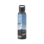 Water bottle with a split blue label showing sky, mountains, and the text 'Your World' across the label.