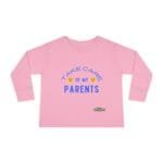 Pink long-sleeve kids' shirt with blue text reading 'Take care of my parents' and small emoji faces for a playful message.