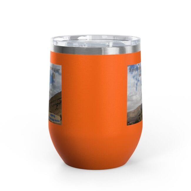 Orange insulated tumbler with a brushed metal rim and two landscape photo stickers on the side.