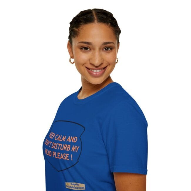 Smiling woman in a blue T-shirt with orange text reading 'KEEP CALM AND DON'T DISTURB MY HEAD PLEASE!'