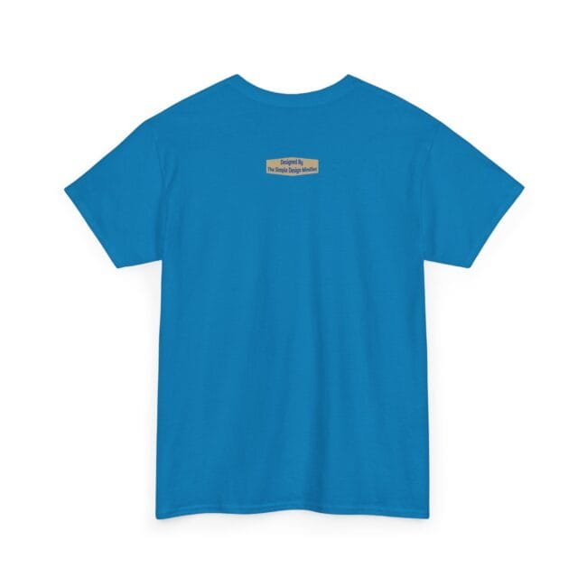 Back view of a bright blue T-shirt with a small beige label at the upper back reading 'Designed by The Simple Design Mindset'.