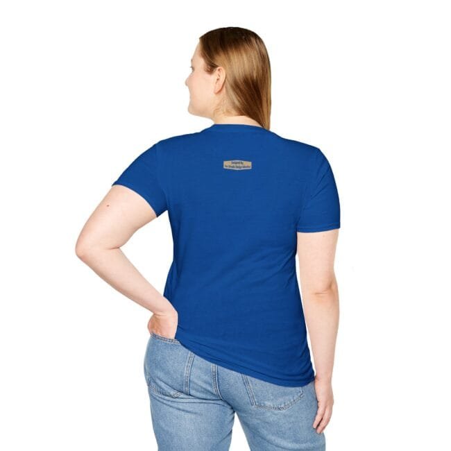 Back view of a person wearing a royal blue t-shirt and light-wash jeans, chin turned slightly to the left, small label on upper back of shirt