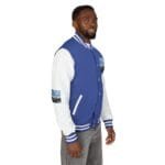 Man wearing a blue and white varsity jacket with patches on the chest and sleeve, shown in profile.