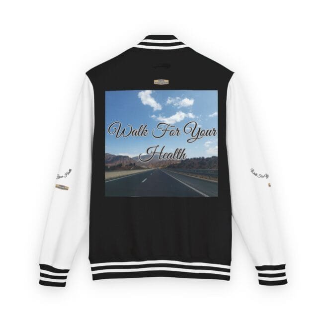 Back of a black-and-white varsity jacket with striped cuffs; large graphic on the back shows a highway scene and the words 'Walk For Your Health' in cursive.