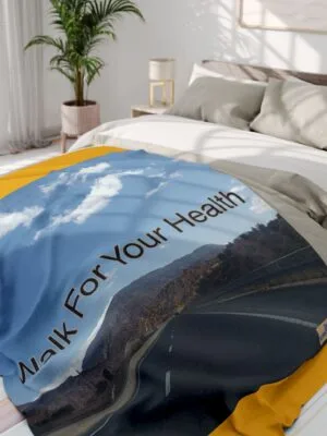 Bed blanket showing a scenic road through mountains with the slogan 'Walk For Your Health'.