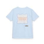Light blue T‑shirt with a lavender decorative frame containing the orange quote: 'Continuous learning is improving your culture's mindset', plus a small designer label at the bottom right of the design.