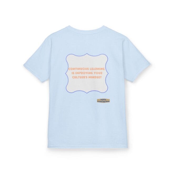 Light blue T‑shirt with a lavender decorative frame containing the orange quote: 'Continuous learning is improving your culture's mindset', plus a small designer label at the bottom right of the design.