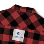 Red and black plaid shirt with a white label patch reading 'The Simple Design Mindset' logo visible on the chest area.