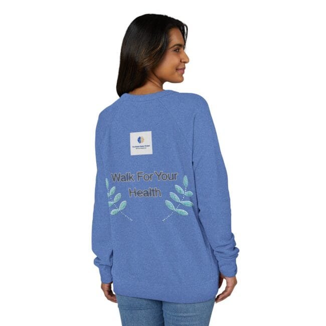 Back view of a woman in a blue long-sleeve shirt, featuring 'Walk For Your Health' with leaf embroidery on the back.