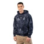 Man wearing a navy tie-dye hooded sweatshirt with a chest graphic reading 'Walk For Your Health' and laurel leaves, standing in beige cargos against a white background.