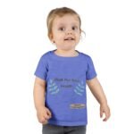 Smiling toddler wearing a blue T-shirt that says 'Walk For Your Health' with leafy designs on the sides.
