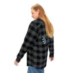 Person wearing a black and gray plaid flannel shirt, seen from behind, with blue leaf embroidery on the back.