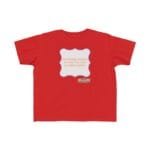 Red children's T-shirt with a white decorative frame in the center bearing orange slogan about continuous learning; a small yellow label below reads 'Designed by The Simple Design Mindset'.