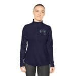 Woman wearing a navy long-sleeve, zip-neck top with a teal laurel emblem on the left chest.
