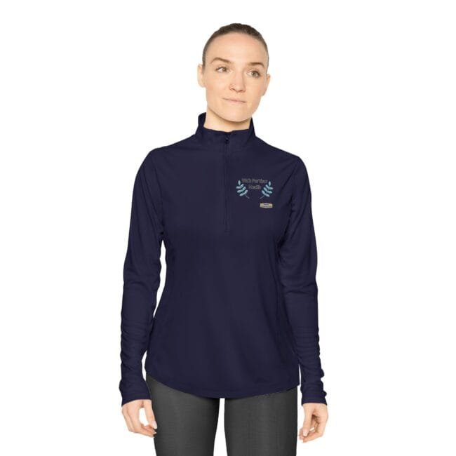 Woman wearing a navy long-sleeve, zip-neck top with a teal laurel emblem on the left chest.