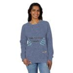 Smiling woman wearing a blue sweatshirt with 'Walk For Your Health' and teal leaf embroidery on the front.
