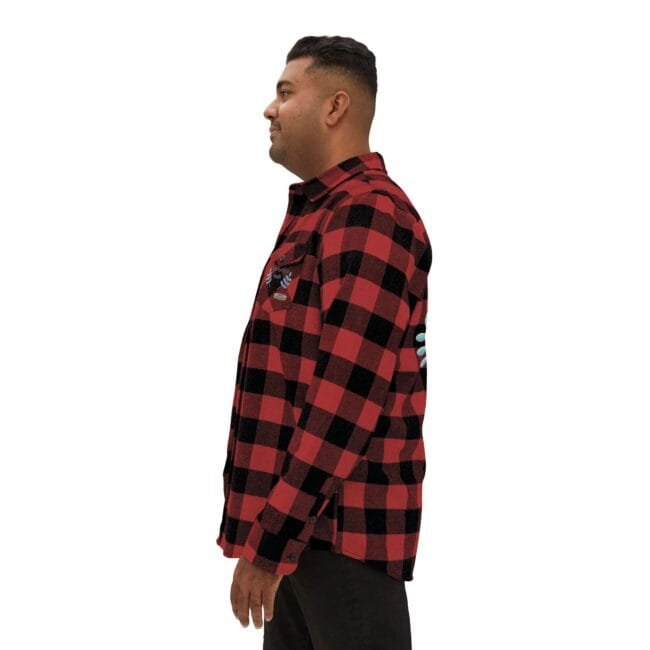 Side profile of a man wearing a red and black plaid flannel shirt with decorative embroidery on the chest area.