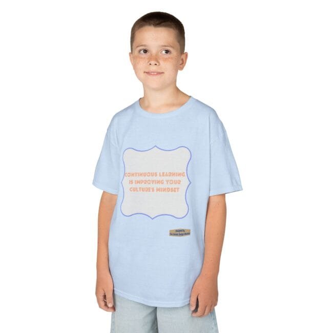 Boy wearing a light-blue T-shirt with a white, purple-framed badge saying 'Continuous learning is improving your culture's mindset'.