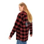 Person wearing a red and black plaid flannel shirt viewed from behind, with embroidery on the back.