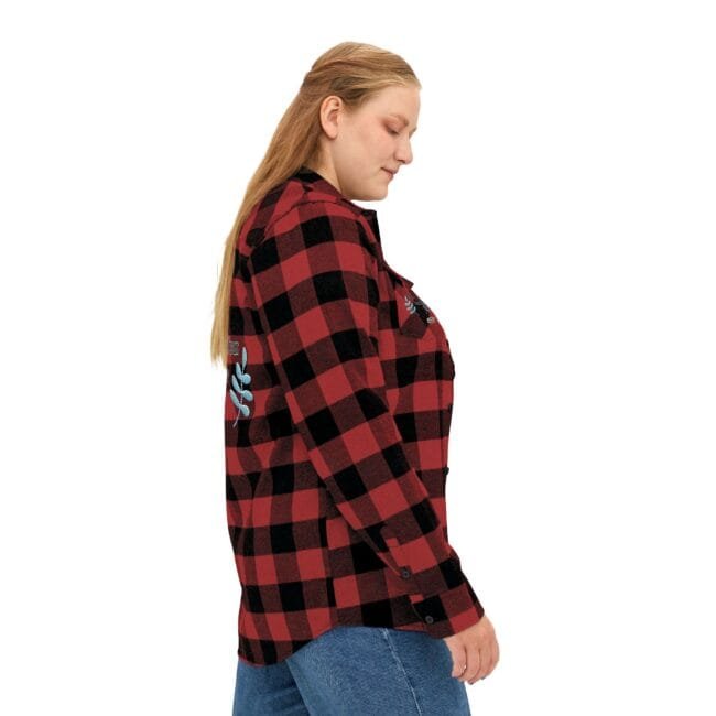 Side profile of a woman wearing a red and black plaid flannel shirt and blue jeans.