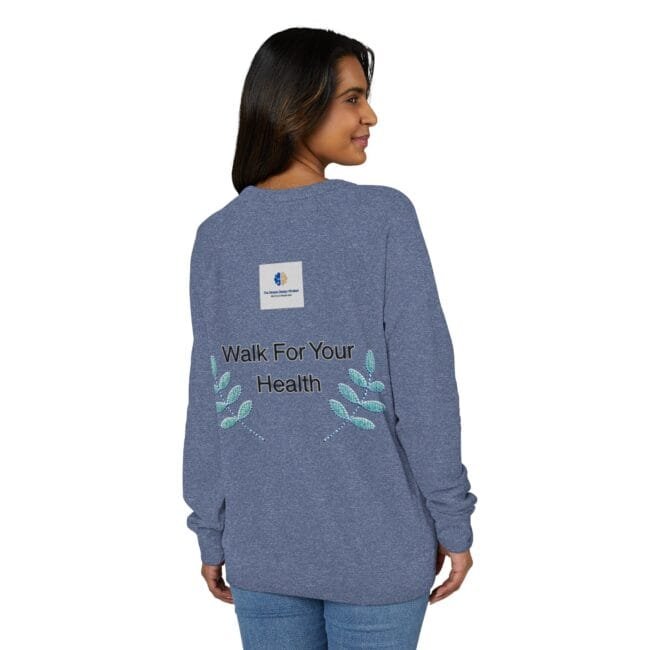 Back view of a woman wearing a blue heathered long-sleeve top with the slogan 'Walk For Your Health' and teal embroidered leaves on the lower back, plus a small square logo above the slogan.
