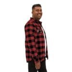 Smiling man in a red and black plaid flannel shirt, shown in profile against a white background