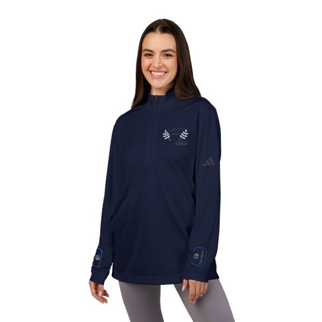 Young woman in a navy quarter-zip athletic pullover with embroidered crest on the chest and patches on the sleeves cuffs.