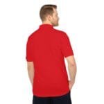 Back view of a man wearing a red polo shirt, with hands in pockets.