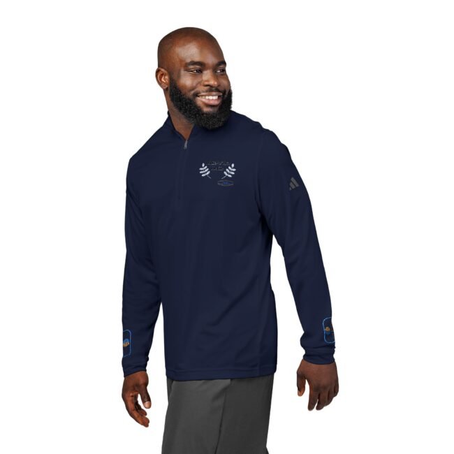 Man wearing a navy quarter-zip pullover with embroidered crest on chest and branding on the sleeve, smiling and looking to the side.